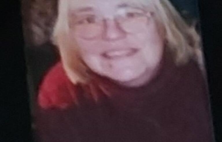A woman with a blonde bob and red top