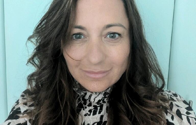 A selfie of a woman with long brown hair