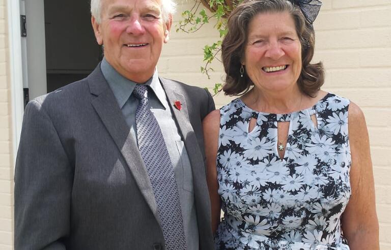 A smiling couple in formalwear