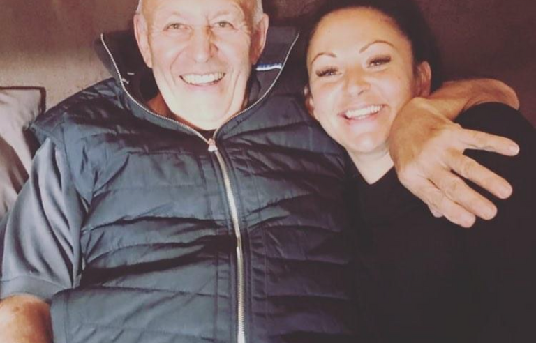 An older man hugging a younger woman