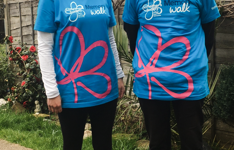 A woman and a man in a garden wearing Memory Walk t-shirts