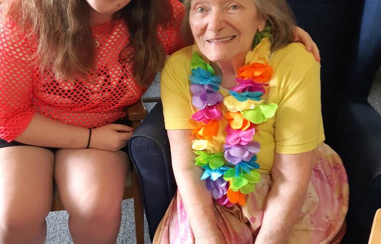 A younger woman and older woman sat on chairs