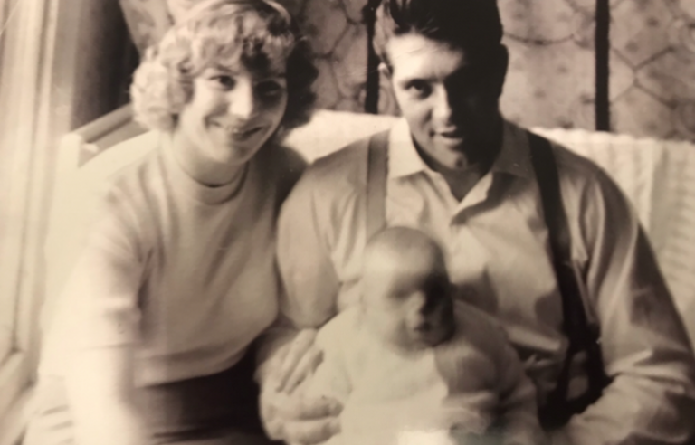 A sepia photo of a man, woman and baby
