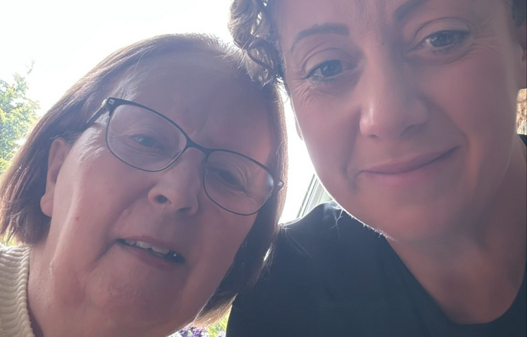 A selfie of a older woman and younger woman