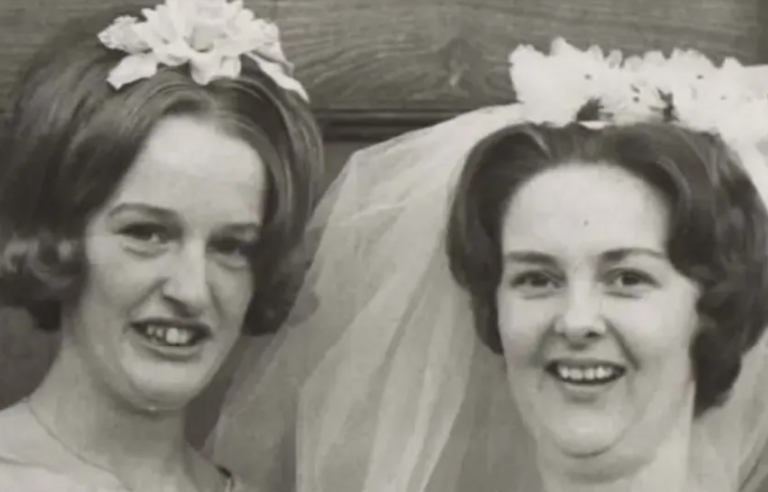 A black and white photo of a bride and her sister