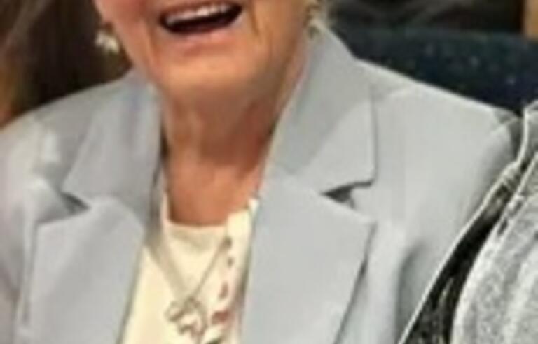 A lady with short grey hair sat down and laughing