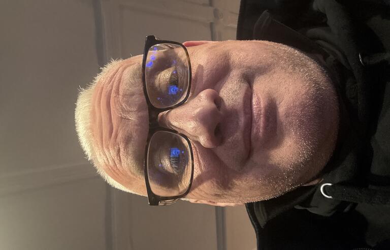 Selfie of a man with glasses and a black top